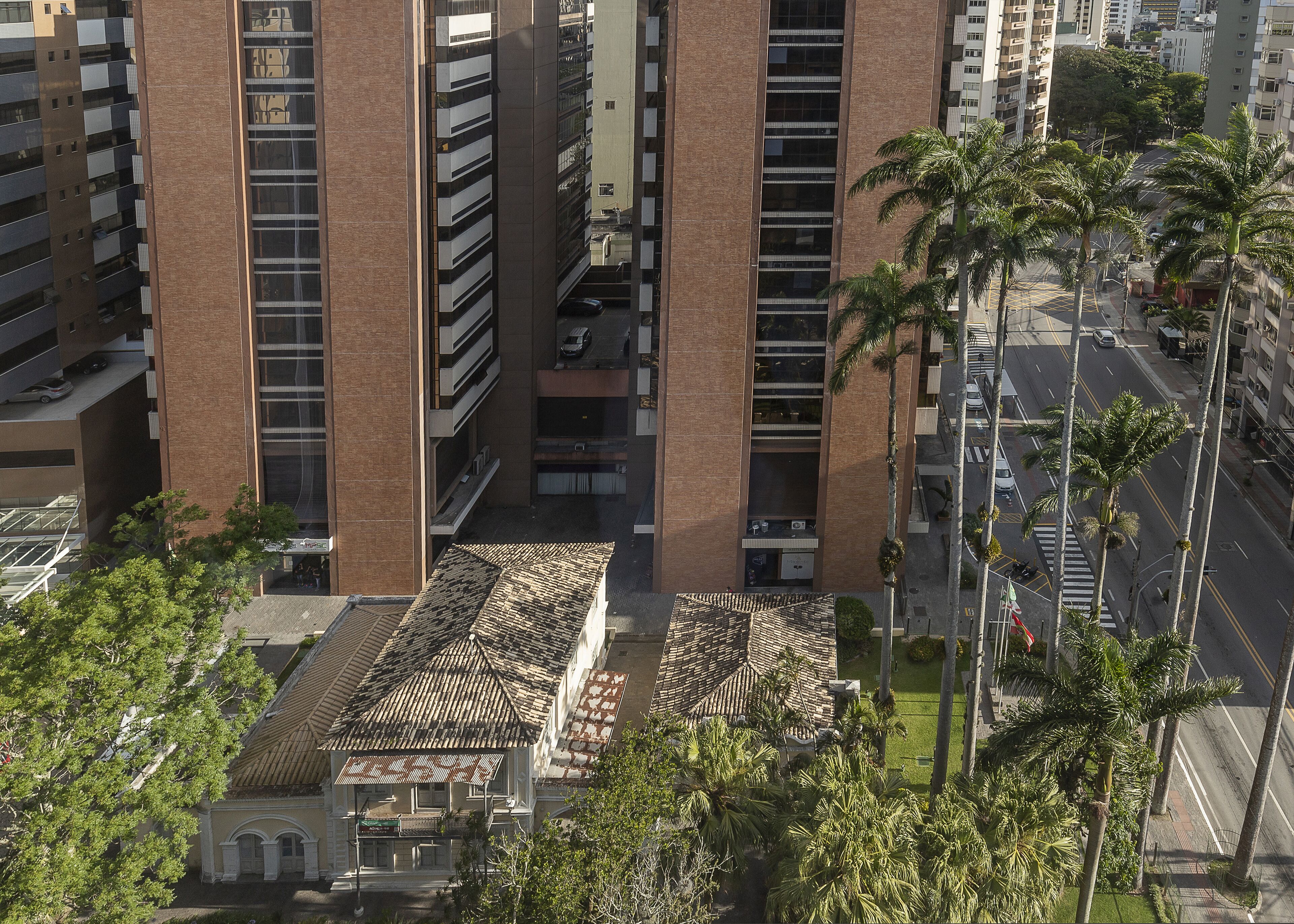 A high-rise building with a modern design, featuring multiple floors and a central courtyard with a patterned roof.