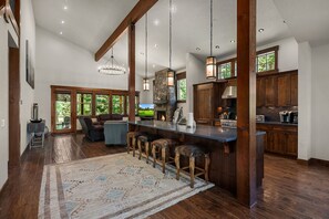 A spacious kitchen with a large island, wooden beams, and a stone fireplace. - Privacy and Luxury! Fantastic outdoor living space. Hot Tub and Game Room (Cle Elum)