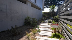 A pathway leading to a gated area with a sign indicating it is private property for residents and guests only.
