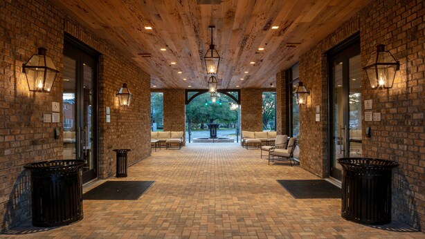 A covered outdoor area with brick walls, wooden ceiling, and seating. - Courtyard by Marriott Thomasville Downtown (Thomasville)