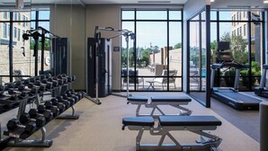 A gym with weightlifting equipment, treadmills, and benches. - Courtyard by Marriott Thomasville Downtown (Thomasville)