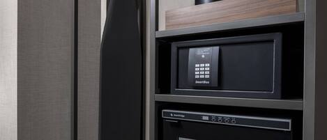 A modern kitchen with a microwave, a coffee machine, and a refrigerator.