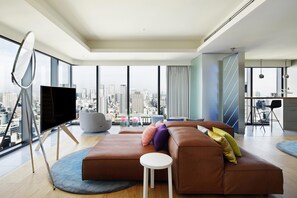 Suite, 1 King Bed | Living area | 55-inch TV with cable channels