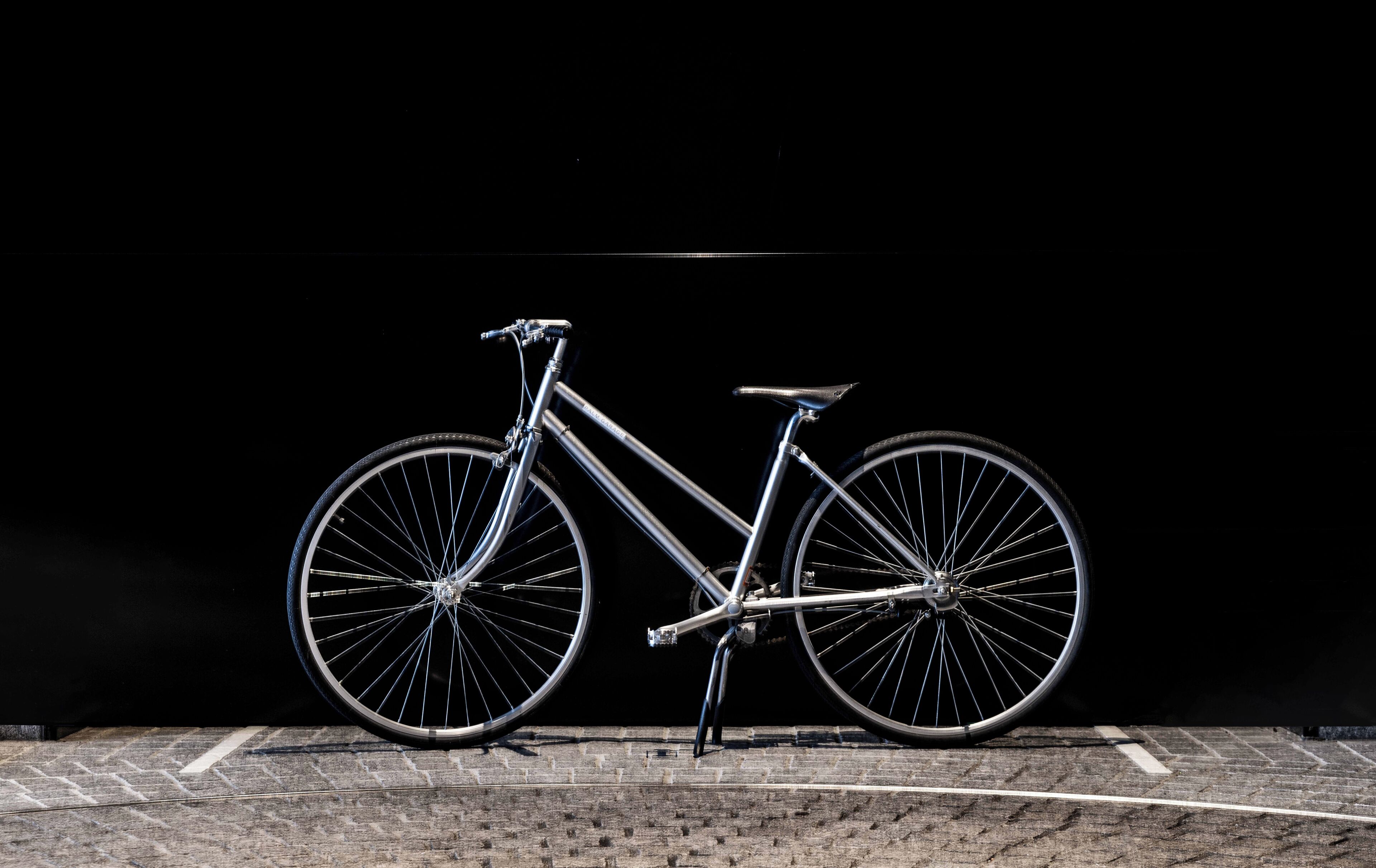 A bicycle parked against a dark background.