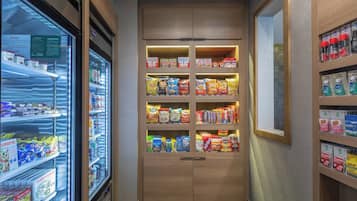 A snack vending machine with various packaged snacks and a refrigerated section.