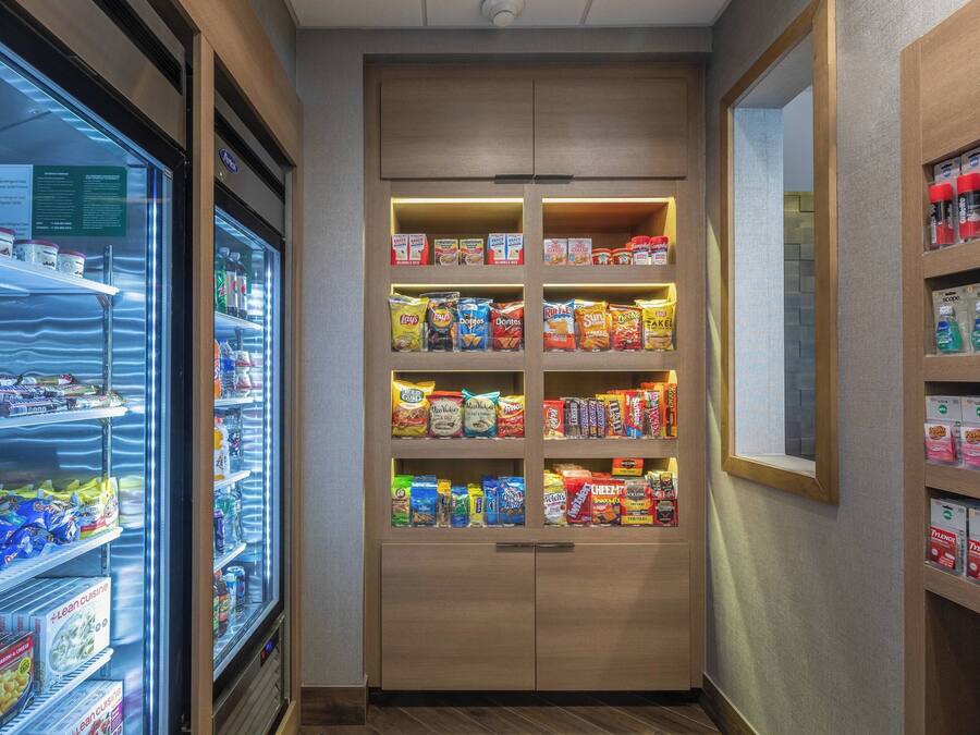 A snack vending machine with various packaged snacks and a refrigerated section.