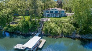 A lakeside house with a dock and a covered boat ramp. - Beautiful Sunrise Views of Hall Lake! (Fairmont)