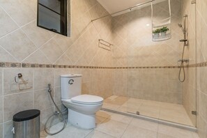 A modern bathroom with a toilet, shower, and a small shelf with plants. - AnB poolvilla 2BR with private beach (Pattaya)