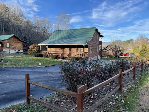 A lodge with a green roof, wooden exterior, and a porch area. - Beautiful Bryson City Oasis ~ Creek on Property (Bryson City)
