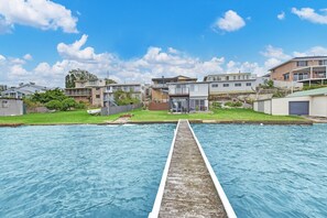 A residential area with a swimming pool, houses, and a clear sky.