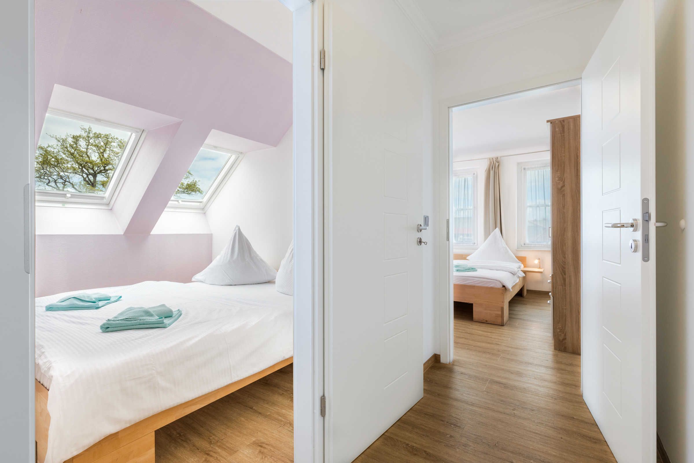 Ein modernes Schlafzimmer mit Oberlichter, Holzboden und Blick ins Freie.