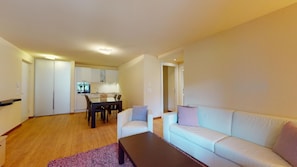 A modern apartment with a living room, dining area, and kitchen. - Modern 3½ room flat on the ground floor, approx. (Madulain)