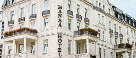 A multi-story building with the name 'Hansa Hotel' prominently displayed.