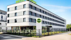 A modern hotel building with a prominent B&B logo, multiple floors, and a glass facade. - B&B Hotel Rostock-Hafen (Rostock)