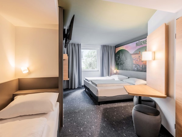 A hotel room with two beds, a desk, a chair, a TV, and a large window.