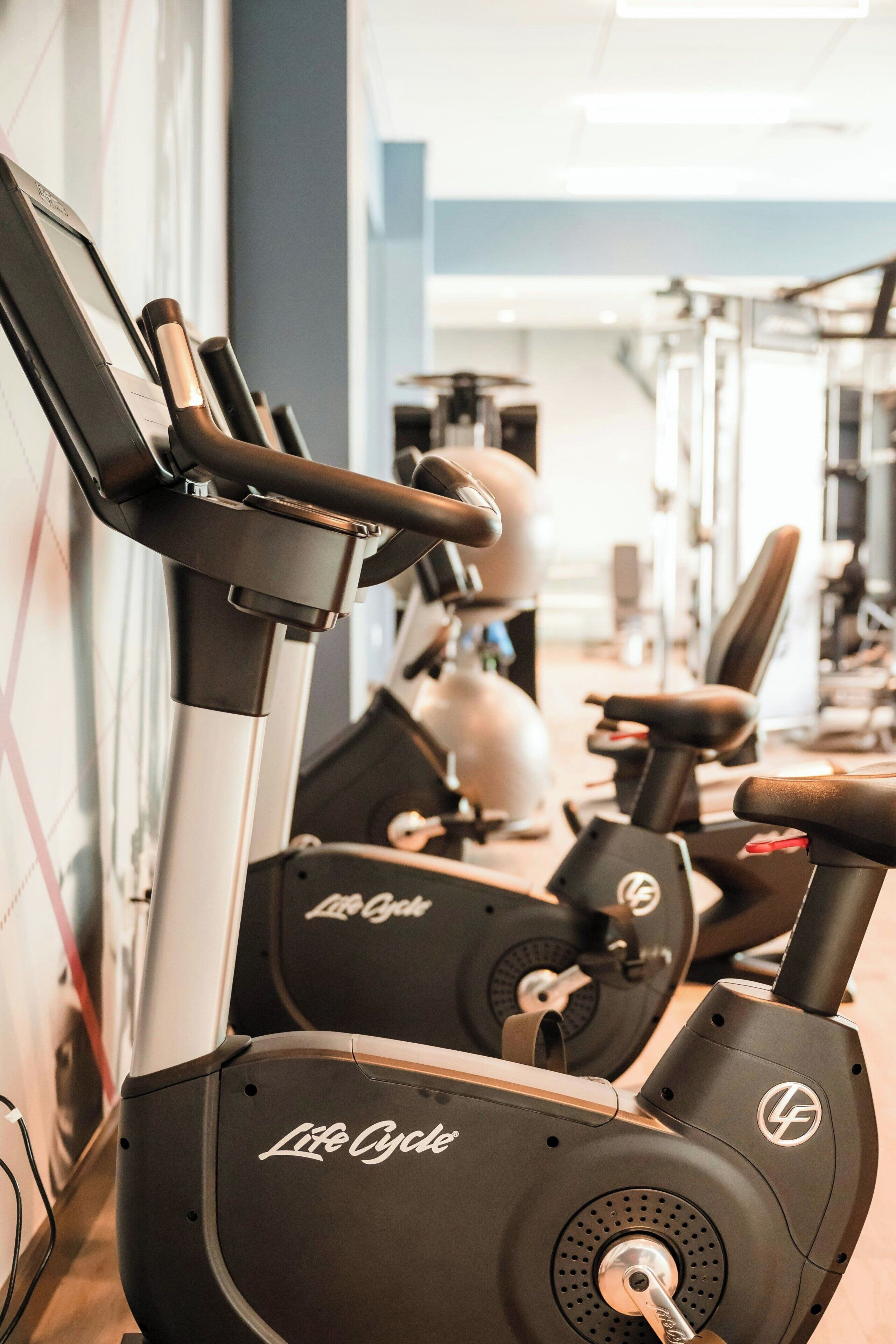 A gym with stationary bikes and exercise equipment.