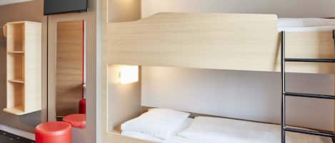A bunk bed room with a television, a shelf, and a red stool.