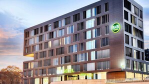 A modern B&B hotel with a flat facade, multiple windows, and a reception area. - B&B Hotel Ulm (Ulm)