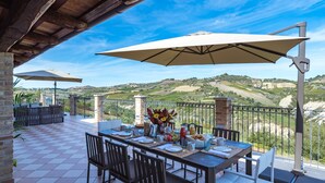 A terrace with a table set for breakfast, overlooking a scenic landscape. - Borgo Da Monte 8, Emma Villas (Monteprandone)