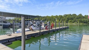 A marina with boats docked, a covered area, and a calm water body. - Enjoy New Arcades & Outdoor Slide, Private Hot Tub, Close to SDC, Free Tickets & Pickleball (Hollister)