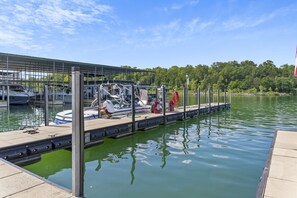 A marina with boats docked, a covered area, and a calm water body. - Enjoy New Arcades & Outdoor Slide, Private Hot Tub, Close to SDC, Free Tickets & Pickleball (Hollister)