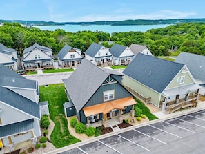 A residential area with houses, a parking lot, and a lake in the background. - Enjoy New Arcades & Outdoor Slide, Private Hot Tub, Close to SDC, Free Tickets & Pickleball (Hollister)