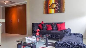 Relax in this stylish living room with a sofa, coffee table, and abstract art.