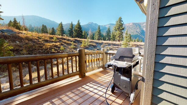 A wooden deck with a grill and a view of mountains. - Snowcreek V 774 Gorgeous Mountain Views with Private Garage, Washer Dryer and Gas Grill by RedAwning (Mammoth Lakes)