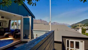 Une maison moderne dotée d’un balcon donnant sur un paysage montagneux.