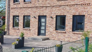 A two-story brick building with multiple windows, a visible door, and a small sign with the number 2018. - The Magic of the Baltic Sea at Ludwigsburg Palace – Experience Nature, the Sea, and Culture (Loissin OT Ludwigsburg)