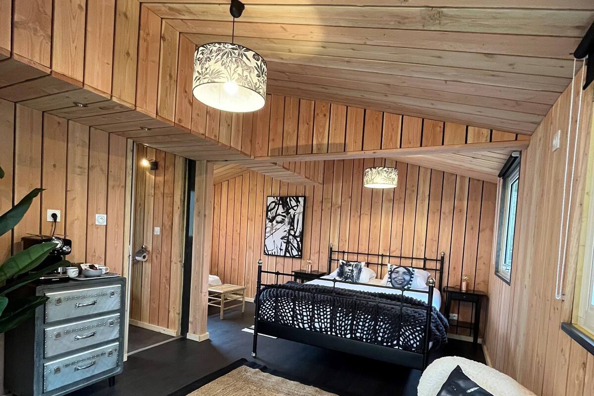 A bedroom with a bed, a dresser, a chair, and a rug.