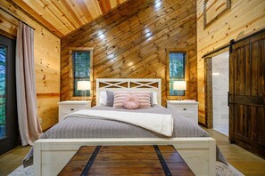Cozy retreat with a large bed, bedside tables, and a window with blinds.