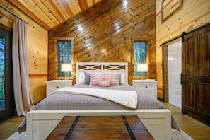 Cozy retreat with a large bed, bedside tables, and a window with blinds.