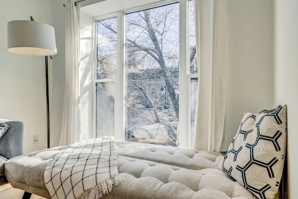 A comfortable daybed, perfect for reading or unwinding, with a view of the outdoors.