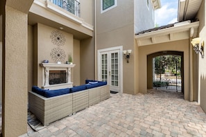 Relax on the covered patio with a sofa set and enjoy the garden views through the glass door.