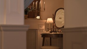 A dimly lit room with a vanity table, a mirror, and a chair. - At Handel's Refreshment House (Vignanello)