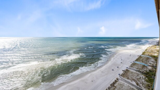 A beach with clear skies and calm waters. - Crystal Shores West 1002- Look No Further This is Where You Need to Be! Reserve (Gulf Shores)