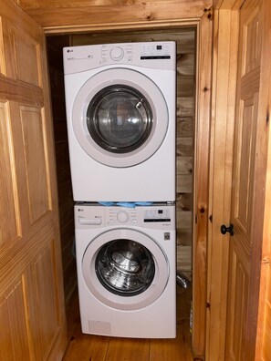 Uma lavanderia com duas máquinas de lavar roupa LG DirectDrive, uma empilhada sobre a outra.
