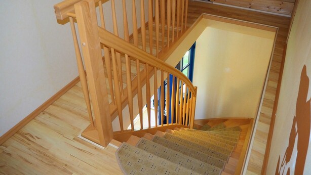 A wooden staircase with a handrail leading to a landing. - Eggers, Sabine Ferienhaus (Insel Poel)
