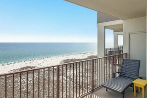 A balcony with a view of a beach and ocean. - Phoenix VI 1515 | Beachfront | Panoramic Top Floor Views! | Covered Parking | My Beach Getaways (Orange Beach)