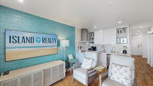 A modern kitchen with white cabinets, a built-in oven, and a coffee machine. - Outstanding Oceanfront Condo with Private Balcony! (Isle of Palms)