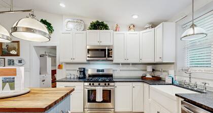 Breezy, renovated home with fenced yard, front porch & lovely living spaces