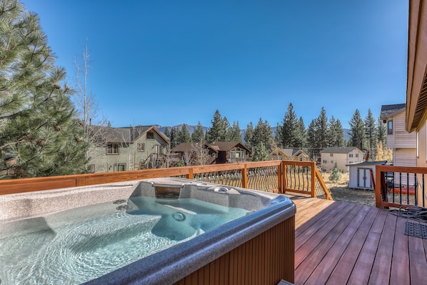 Relax in the hot tub on the deck with a panoramic view of the surrounding neighborhood.
