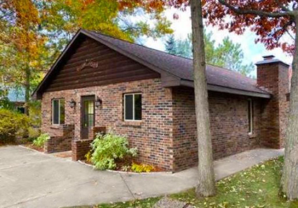 A single-story brick building with a pitched roof, a front entrance, and a small porch area.