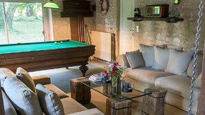 A cozy living room with a pool table, comfortable seating, and rustic decor. - Charming B&B close to the D-day beaches and to Bayeux (Mosles)