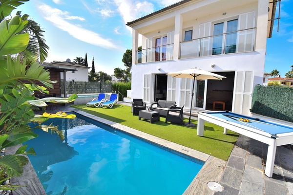 modern holiday home with swimming pool surrounded by nature