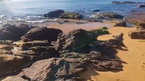 A rocky beach with clear water and distant hills. - Waterfront with private jetty and sunset views. Boat access only. Pet friendly. (little wobby)