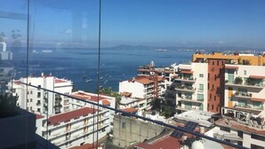 A coastal cityscape with buildings and a view of the sea.
