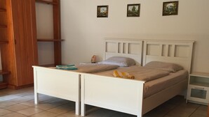 A bedroom with a bed, bedside tables, a wooden wardrobe, and a small shelf. - Apartment no.2 climatic health resort, pearl of the Neckar valley (Hirschhorn am Neckar)