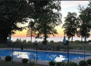 Relax by the pool surrounded by lush trees and ocean views.